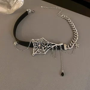 Close-up detail of a dark spider web choker with leather strap and cascading silver chains