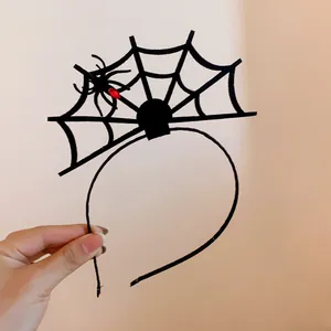 Detailed view of black Halloween spider web headband with red gem spider accent