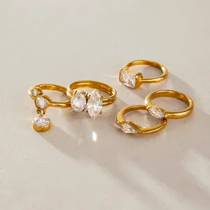 Close-up detail of titanium steel rings set with clear faceted teardrop and marquise zircons