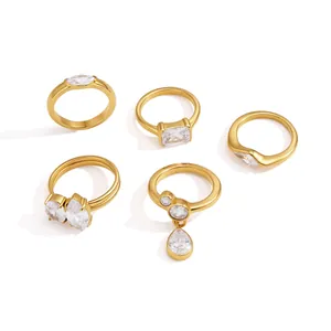 Collection of five gold-tone titanium steel rings with various zircon stone shapes.