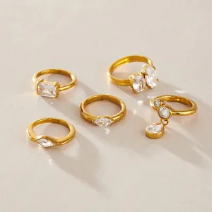 Macro shot of gold titanium steel rings with diverse cubic zirconia stone shapes