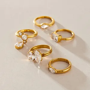 Close-up of gold-plated stainless steel rings set with various shaped clear zircons