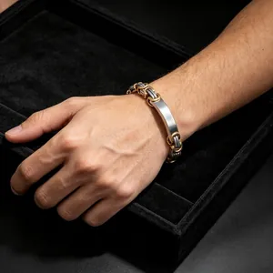 Macro view of a men's titanium steel Byzantine bracelet with a smooth metal plate