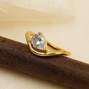 Minimalist irregular gold-plated ring featuring a sparkling pear-cut cubic zirconia stone.