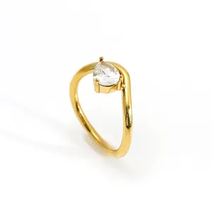 Minimalist irregular gold wavy ring with pear-shaped cubic zirconia stone detail