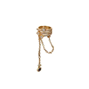 Elegant gold ear cuff with zircon flower motifs and long hanging chain tassels