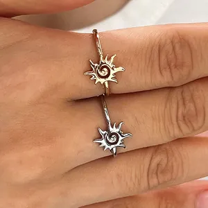 Macro detail of vintage sun adjustable rings in gold and silver finishes on fingers