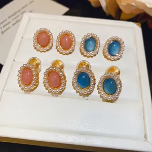 Elegant oval resin pearl earrings in pink and blue with silver needles and clip-on options.