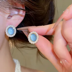 Elegant resin oval stud earrings with pearl halo and a luxurious high-end design for women