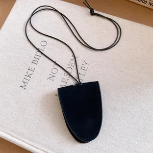 Detailed macro shot of minimalist black suede pendant with elegant wax cord for eyeglasses