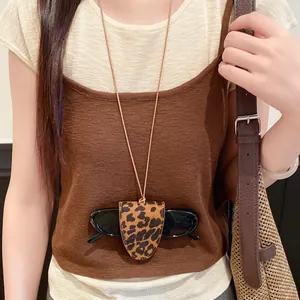 Detailed view of stylish leopard print leather pendant glasses holder necklace on model