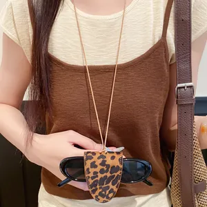 Detail of leopard print leather glasses holder necklace worn as a chic fashion accessory.