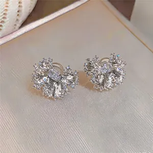 Close-up macro view of elegant sparkling pleated ear clips with oval zirconia stones.