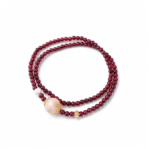 Elegant double-strand garnet beaded bracelet accented with natural stones and pearls