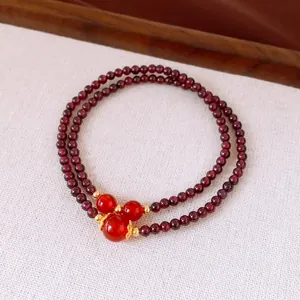 Close-up of vintage garnet double-layer bracelet with red stones and gold accents