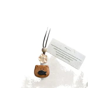Handmade wood cat and fish necklace with vintage woven cord and flower bead details.
