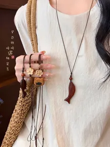 Handcrafted wooden fish and flower necklaces with woven rope in retro ethnic style