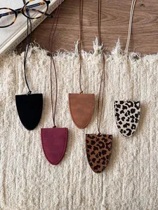 Leather leopard print eyeglass holder necklaces in various colors displayed on fabric.