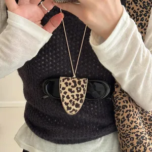 Leopard print leather sunglasses holder necklace lanyard for women shown in use as an accessory