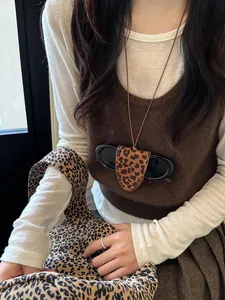 Close-up of leopard print leather sunglasses holder necklace on model