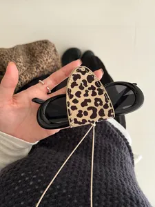 Detailed view of a stylish leopard print leather glasses holder worn as a necklace.