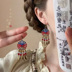 Handcrafted ethnic round woven drop earrings featuring bronze leaf charms and colorful beads