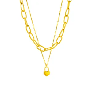 Close-up detail of a double-layered gold-plated stainless steel heart lock pendant necklace