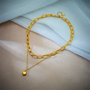 Detailed view of the double-layered gold stainless steel necklace with heart lock.
