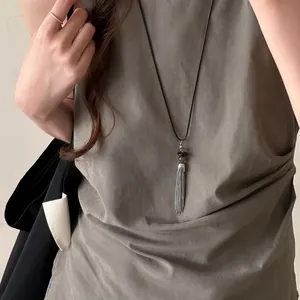 Close-up of a New Chinese style silver tassel beaded necklace on a model.