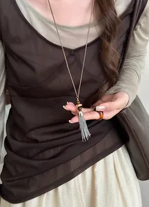Detail view of a silver tassel beaded necklace with a New Chinese style aesthetic