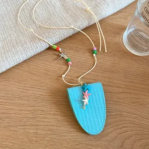 Close-up of a light blue leather glasses bag necklace featuring colorful beads and starfish charms
