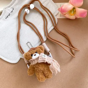 Brown plush bear pendant phone chain with pink knit scarf and long woven rope strap