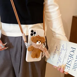 Adorable brown plush bear phone charm featuring a crossbody strap and pink scarf detail