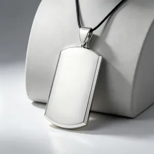 Close-up of a polished blank silver dog tag pendant on a black cord necklace.