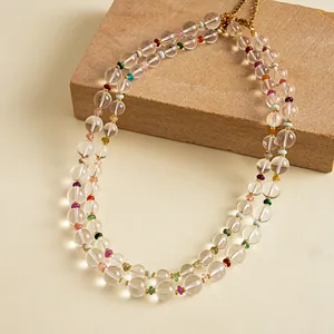 Detailed view of a double-layer necklace with clear crystal-like beads and colorful spacers