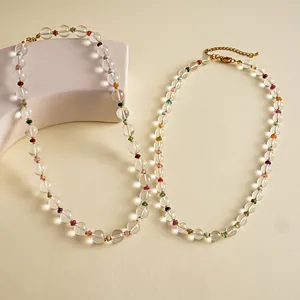 Macro detail of clear glass beads and colorful accents on a minimalist chain necklace