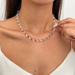 Detailed view of a simple beaded clavicle chain with clear glass and colored beads