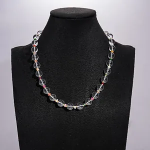 Detailed view of clear glass bead necklace with colorful accents on display