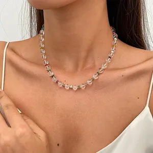 Detailed view of a minimalist beaded necklace with clear and multi-colored accents