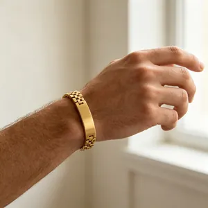 Detail view of a gold-toned titanium steel men's bracelet with engravable curved plate