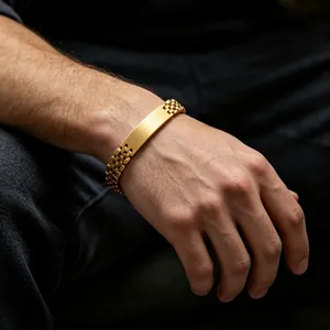 Detail of gold watch band style men's bracelet with polished engravable plate