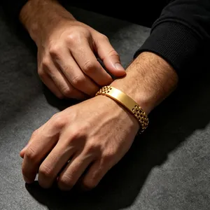 Detail view of a men's gold titanium steel bracelet with watch band style and flat plate