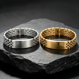 Close-up of gold and silver titanium steel bracelets with watch-style links on stone