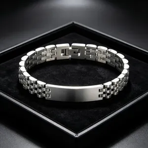 Close-up of stainless steel men's bracelet with watch link band and engravable plate
