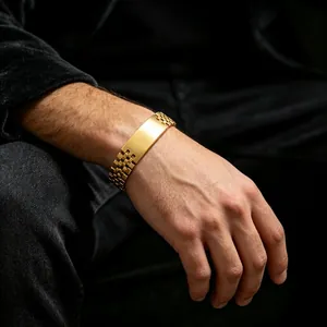 Close-up of a gold titanium steel men's bracelet with a glossy plate and link chain.