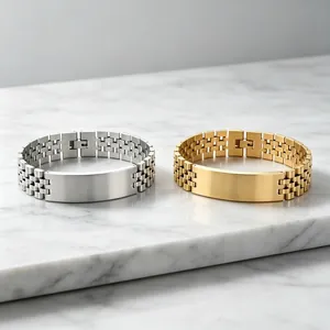 Silver and gold titanium steel watch strap style bracelets for men on marble surface
