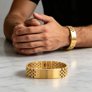 Detailed view of a gold titanium steel men's bracelet on a marble surface