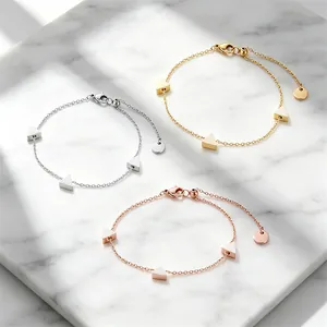 Detailansicht von drei minimalistischen Titanstahl-Armbändern mit Dreieck-Anhängern