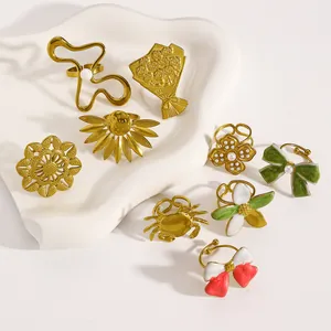 Collection of vintage enamel flower, bow, and crab design stainless steel rings