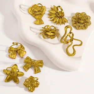 Assortment of vintage gold stainless steel open rings with flower and bow designs.